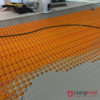 Self-adhesive decoupling mat with lug design for loose wire cables